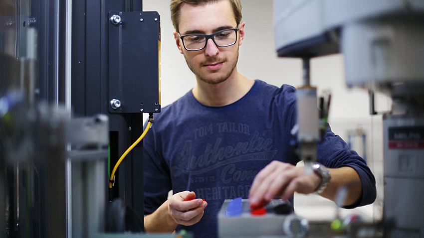 Young man at a machine